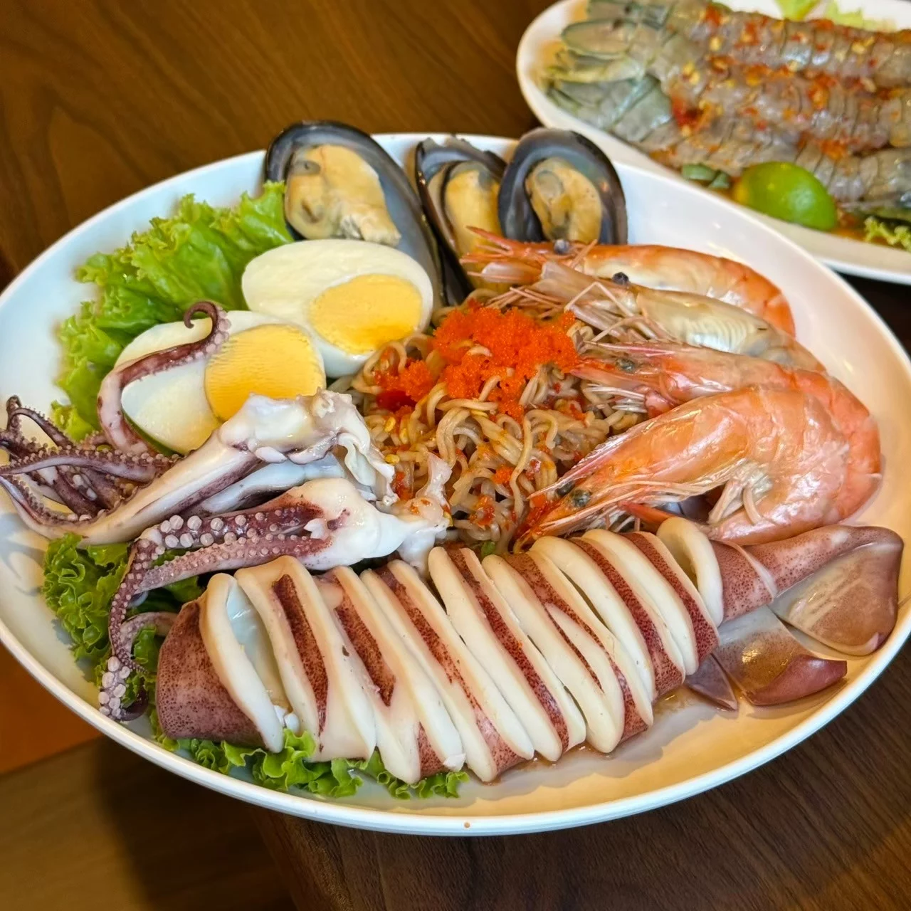 จานรวมซีฟู้ดที่มีกุ้ง หมึก และหอยพร้อมเครื่องเคียง